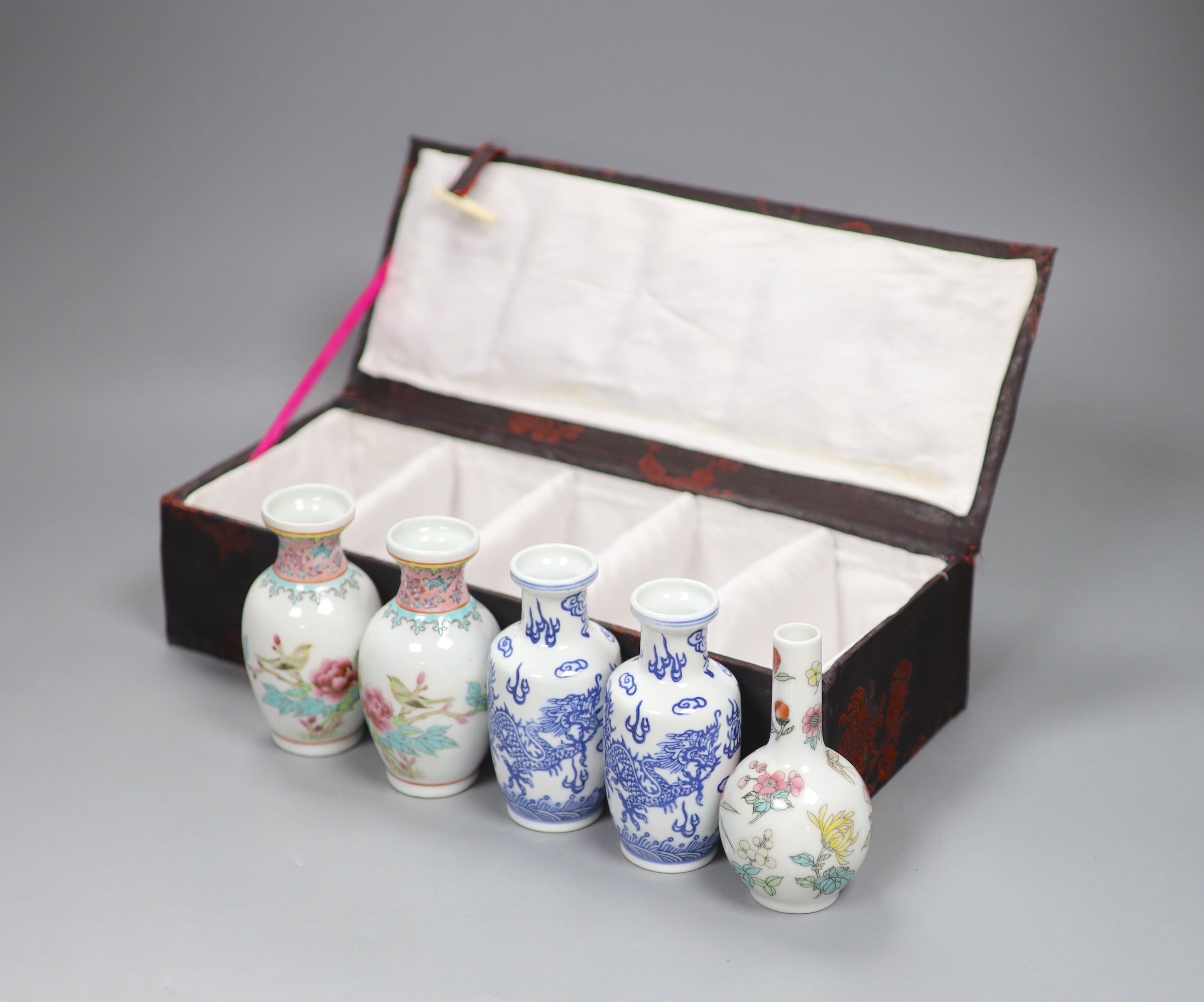 A boxed set of five small Chinese vases